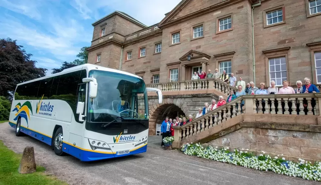 Whittles coach at stately home with people